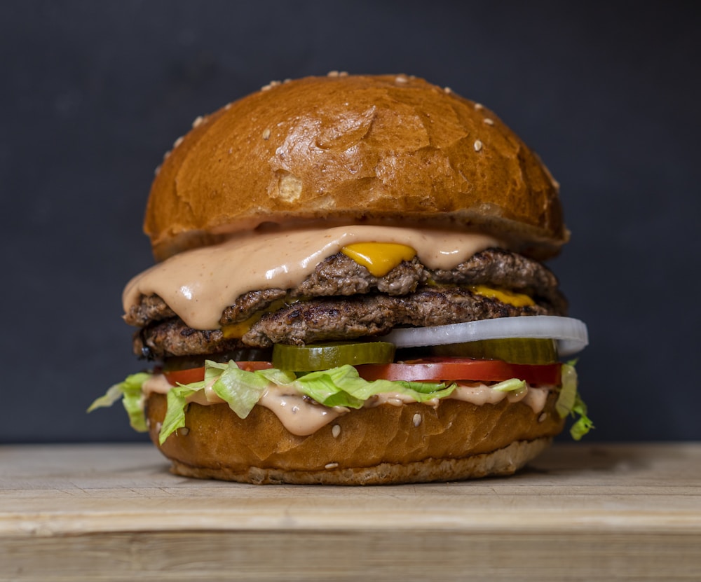 A juicy burger stacked with fresh tomato, cheese, and lettuce